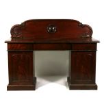 A Victorian figured mahogany pedestal sideboard, the raised back above three frieze drawers with