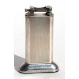 A silver plated Dunhill table lighter with engine turned decoration, 10cms (4ins) high.