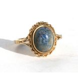 A 9ct gold ring set with a hardstone cabochon, approx UK size 'L'.