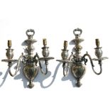 A pair of silver plated twin-arm wall lights, 34cms (13.5ins) high.