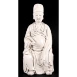 A Chinese blanc de chine style figure depicting Wen Chang holding a rui sceptre. Impressed seal mark