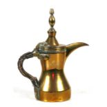 A Turkish / Islamic brass dallah coffee pot, 26cms (10.25ins) high.