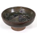 A Studio Pottery footed bowl decorated with a stylised fish, 28cms (11ins) diameter.