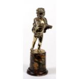 A bronze figure in the form of a putti, mounted on a marble plinth, 23cms (9ins) high.