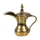 A Turkish / Islamic brass dallah coffee pot, 19cms (7.5ins) high.