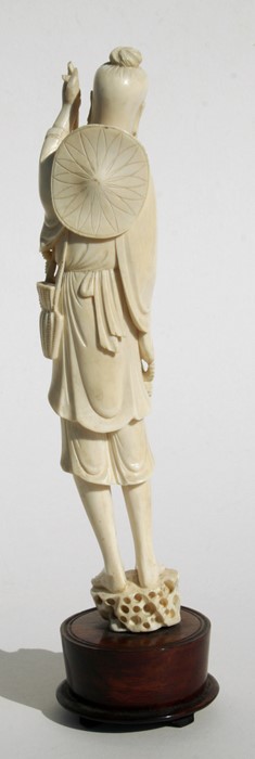 A late 19th / early 20th century Chinese carved ivory figure of a fisherman holding his catch, 28cms - Image 2 of 2