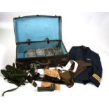 A large military leather suitcase with contents including mess tins and a WW2 newspaper