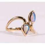 A 9ct gold opal and diamond crossover ring, approx UK size 'J'.