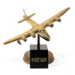 A brass model of the WW2 Sunderland flying boat standing on its brass base, marked on the
