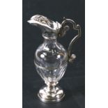 A cut glass ewer with silver plated mounts, 16cms (6.25ins) high.