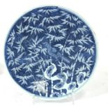 A blue & white charger decorated with a bird amongst bamboo, 33cms (13ins) diameter.Condition Report