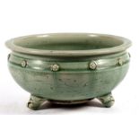 A Chinese celadon glaze bowl standing on three legs. 26cm (10.25 ins) diameter