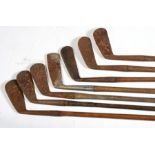 A quantity of hickory shafted golf clubs.