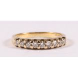 A 9ct gold diamond half eternity ring, approx UK size 'K'.