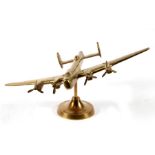 A large brass model of the WW2 heavy bomber the iconic Avro Lancaster with spinning propellers