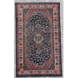 A modern Persian rug with central medallion on a blue ground, 80 by 150cms (31.5 by 59ins).