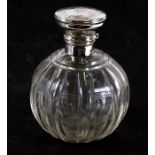 A silver topped cut glass scent bottle; together with two pierced silver dishes (3).