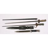 A quantity of militaria to include bayonets, trench art, spurs and shrapnel.