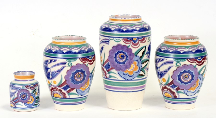 A group of four Poole Pottery vases decorated with birds and flowers, the largest 24cms (9.5ins)