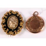 A 9ct gold locket; together with a Victorian yellow metal mourning brooch (2).