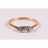 A 9ct gold three-stone dress ring, approx UK size 'M'.