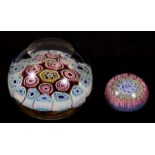 A millefiori glass paperweight, 7cms (2.75ins) diameter; together with a smaller similar, 4cms (1.