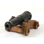 A 20th century signal cannon. Having a steel barrel 15cms (6ins) long mounted on a wooden carriage