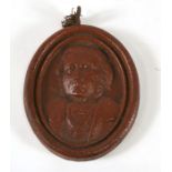 A 19th century oval stoneware plaque possibly depicting William Ewart Gladstone, 14cms (