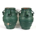 A pair of painted terracotta garden urns, 47cms (18.5ins) high.
