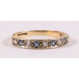 A 9ct gold half eternity ring set with pale blue & white stones, approx UK size 'M'.