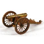 A brass & wood model of a field cannon, 24cms (9.5ins) long.