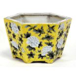 A Chinese hexagonal tapering form planter decorated with chrysanthemums on a pale yellow ground,