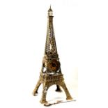 A Victorian brass mantle clock in the form of the Eiffel Tower, the gilt dial with Arabic