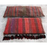 A Bedouin woollen handmade camel saddlebag; together with a similar large floor cushion (2).