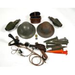 A quantity of militaria, to include helmets and headphones.