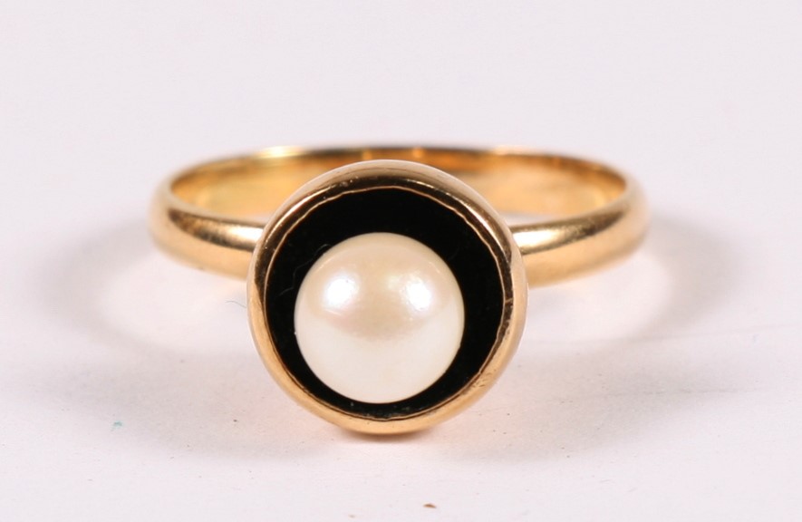 A yellow metal (tests as 18ct) ring set with a single pearl. Appox UK size L