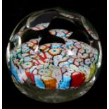 A faceted millefiori glass paperweight with ground out pontil mark, 8cms (3.25ins) diameter.
