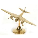 A WW2 brass model of the De Havilland Mosquito with spinning propellers mounted on its brass
