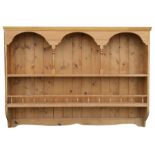 A wall mounted pine plate rack, 129cms (50.25ins) wide.
