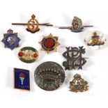 Ten assorted military lapel badges and sweetheart brooches including silver