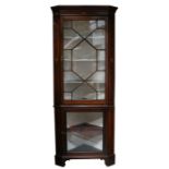 An Edwardian inlaid mahogany corner cupboard, the astragal glazed top enclosing a shaped shelved