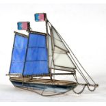 A decorative glass & metal three-masted sailing ship, 28cms (11ins) long.