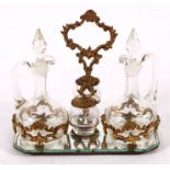 An etched glass & gilt metal condiment set on stand, to include two oil bottles and two salts, 24cms