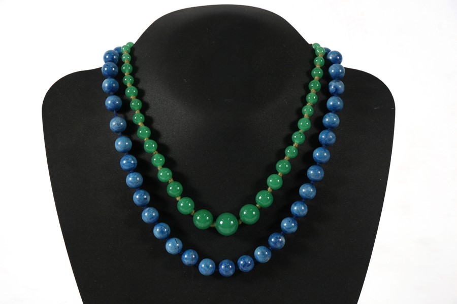 A graduated green glass bead necklace; together with a blue hardstone bead necklace (2).
