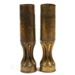 A matching pair of trench art shell case vases engraved with the Cross of Lorraine and foliage.