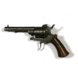 A steel six-shot pin fire pistol with walnut grip, 19cms (7.5ins) long.