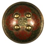 An Indo-Persian brass dhal shield, 27cms (10.5ins) diameter.