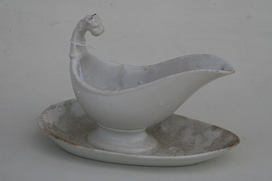 A 19th century white glazed gravy boat on stand with lion mask handle.Condition Report Good - Image 4 of 5
