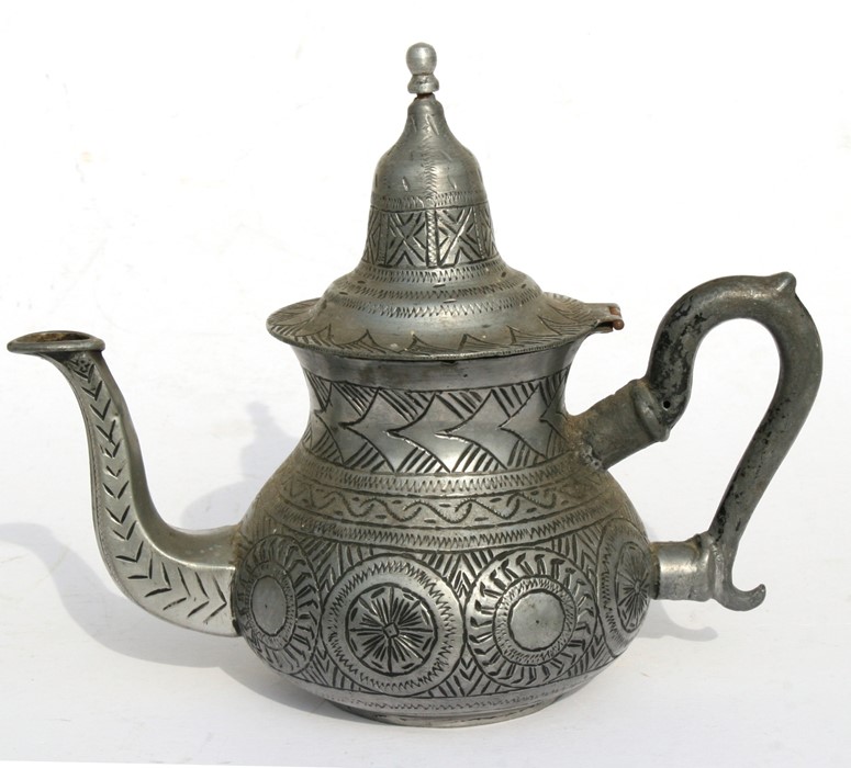 A pewter teapot with incised decoration with bee mark to underside, 20cms (8ins) high.
