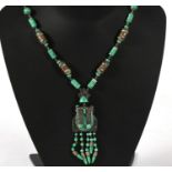 An Art Deco style mottled green glass and filigree metal necklace & pendant.